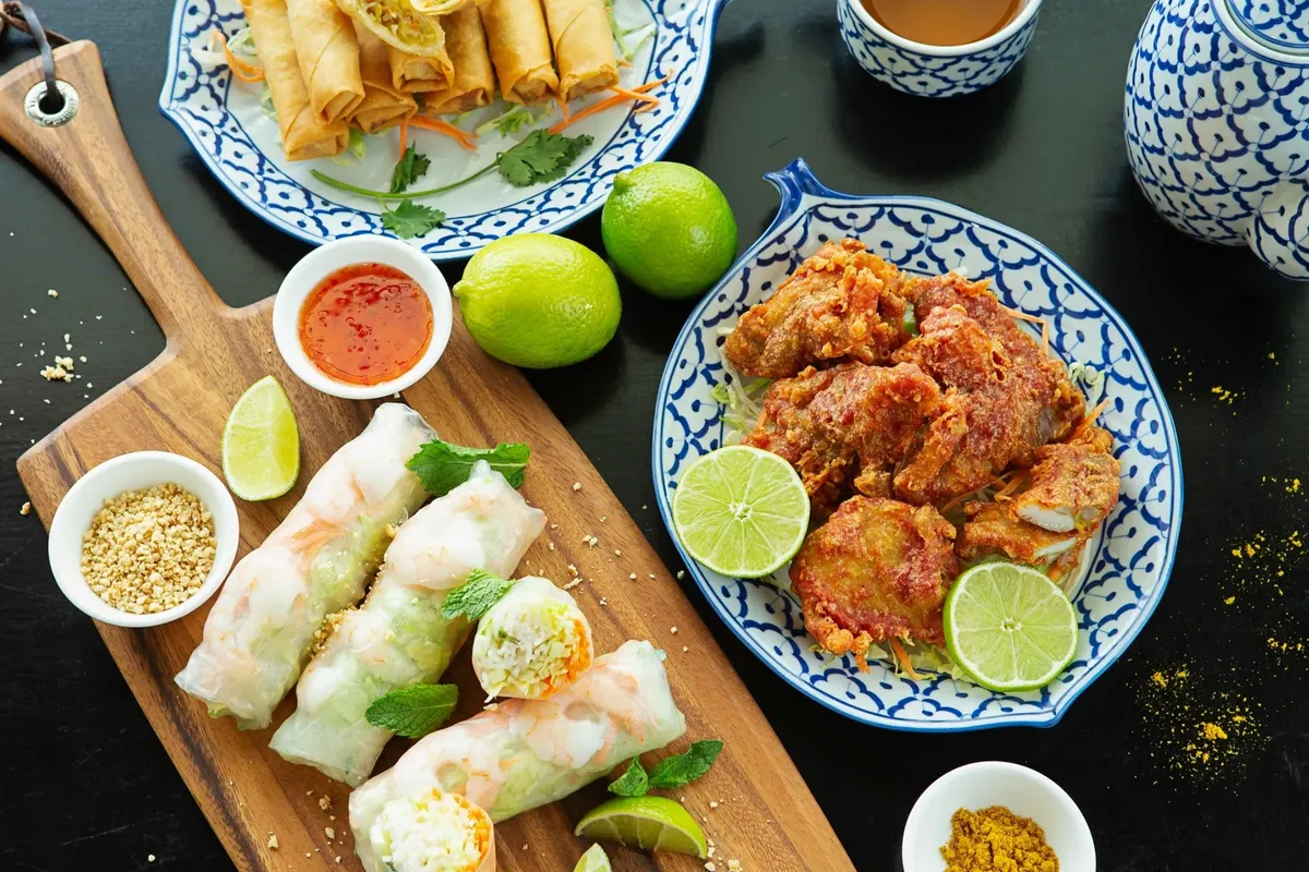 Sharing plates of Lao and Thai dishes on the table at Kin Dee Street Kitchen in northeast Calgary